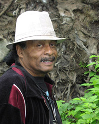 Joseph Scott Joseph Scott is outside wearing a black shirt and white bucket hat.
