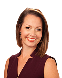 Emily Wahls is wearing a maroon top for a professional headshot photo.