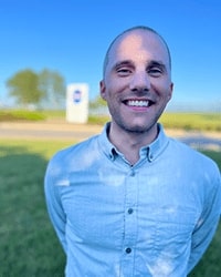 This is a headshot of Troy Lyons standing outdoors.