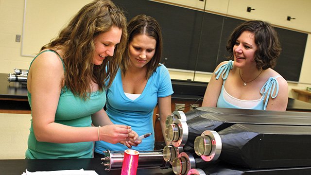 rethman a group of women looking at a piece of metal