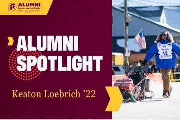 A CMU Alumni Spotlight graphic featuring an image of Keaton Loebrich, '22, racing in a blue parka running next to his sled and dogs.
