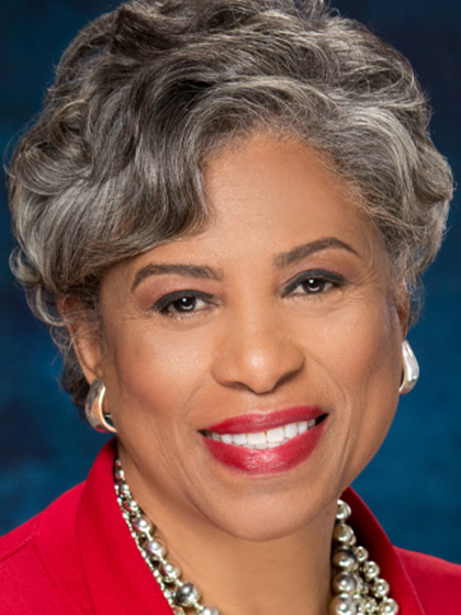Congresswoman Brenda Lawrence with a bright red suit jacket and jewelry on.