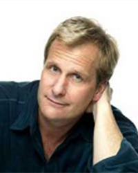 Actor Jeff Daniels wearing a blue shirt while resting his head against his left hand.