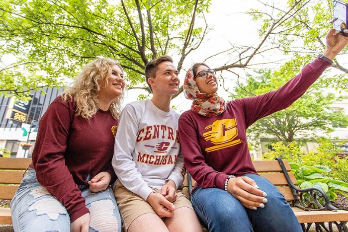 Three people wearing CMU gear and taking a selfie.