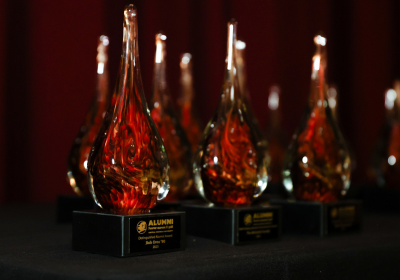 Several red glass awards arranged in a row.