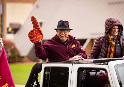 President and Cindy Davies in a roofless Jeep in the Homecoming parade.