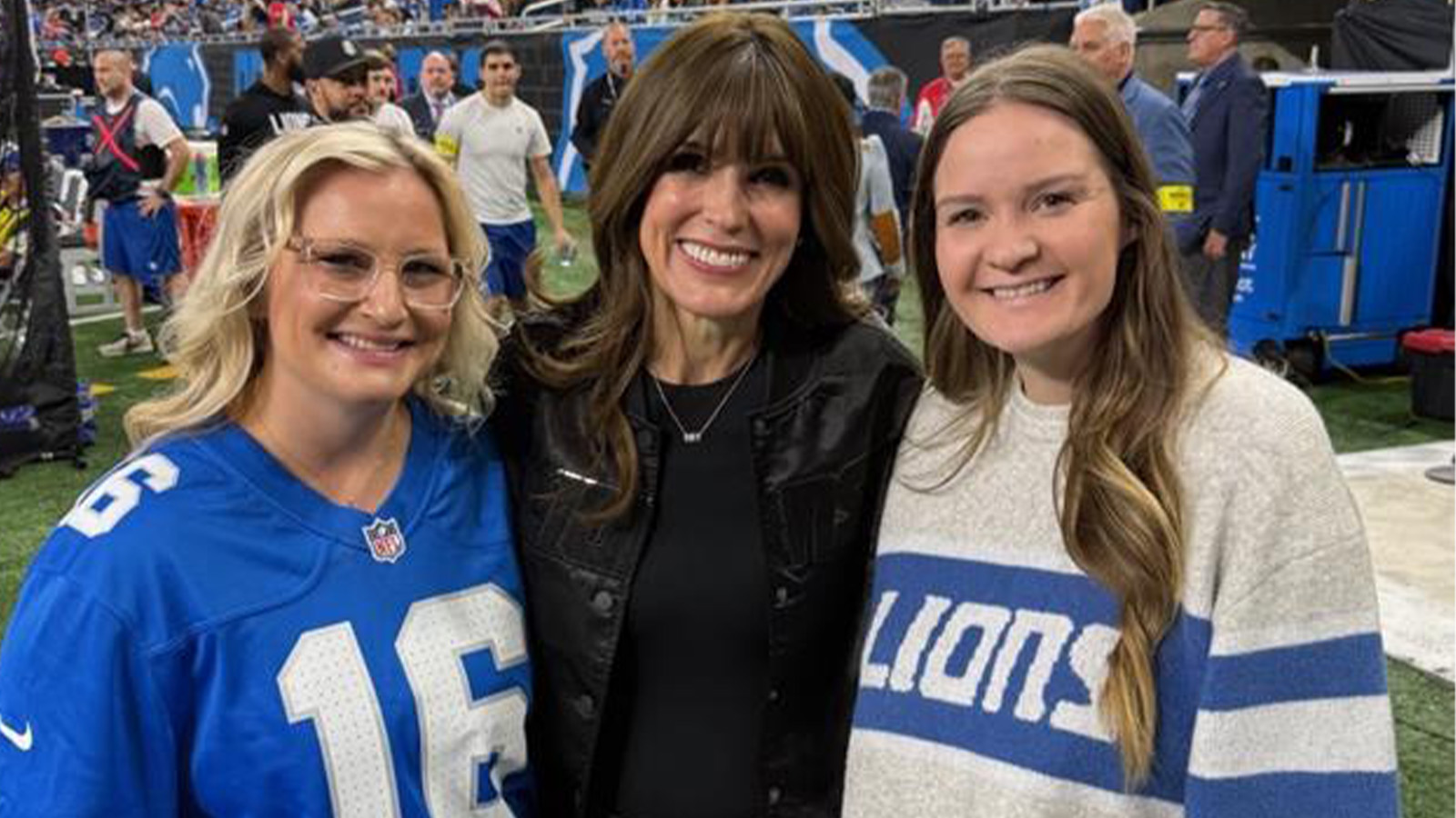A group of women posing for a picture at a Detroit Lions game.
