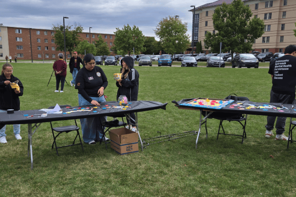 acompass wellness fiar 2025 600x400 Four students from COMPASS at the the Wellness Fair outside at activity tables