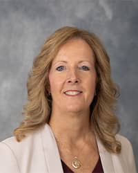 Melissa Hutchinson, Executive Director of Counseling Services Melissa Hutchinson, Executive Director of Counseling Services profile portrait, wearing white blazer against a grey background.