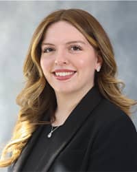 Kyleigh Ayala, Counselor profile portrait, wearing a black shirt, black blazer and a grey background.