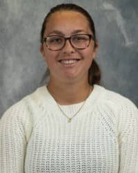 200x250 26-10-01_Kennedy-ONeal-1 Kennedy O'Neal, COMPASS Peer Educator. Dark hair pulled back in a ponytail. Wearing a white sweater, glasses, necklace, and in front of a grey background.