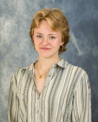 200x250 26-10-05 Stephania Daksiewicz-3 Stephanie Daksiewicz, Oros Well-th Scholar and COMPASS Peer Educator. Short blonde hair, wearing a striped button down shirt in front of a blue background.