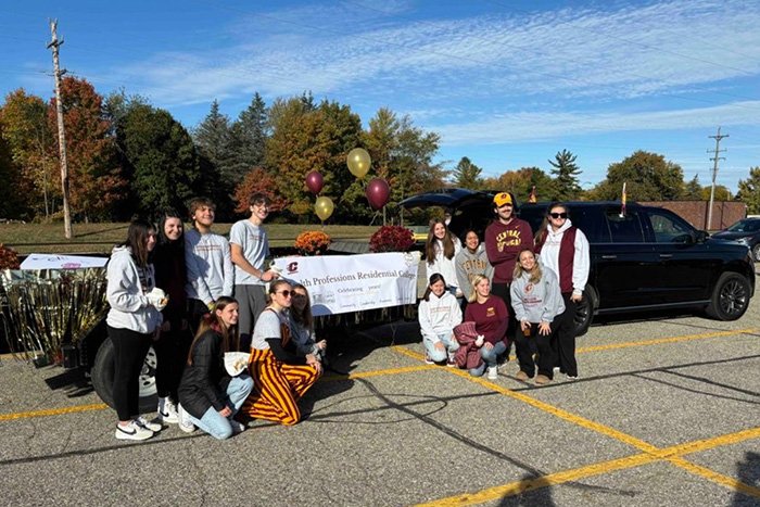 Homecoming 2024 - 25th Year Celebration of the HPRC Students in front of the Homecoming float celebrating 25 years of Health Professions Residential College.