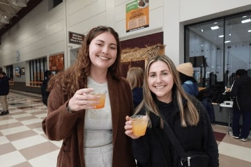 students pose at fire up all night holding mocktails