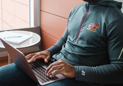 Student on a laptop in a well-lit environment indoors.