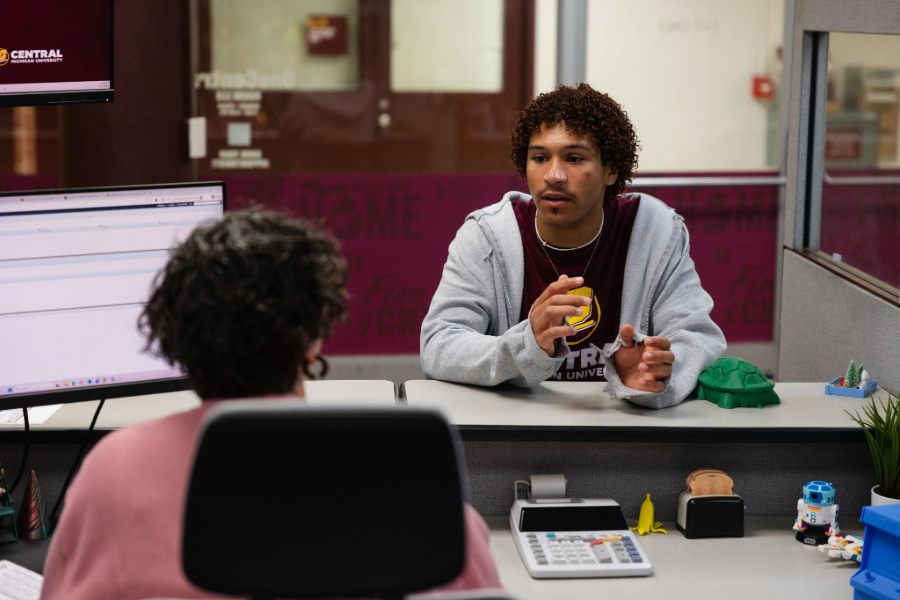 -061926 One Central Office as-0013 CMU Student in the admissions office discussing with staff at the front desk