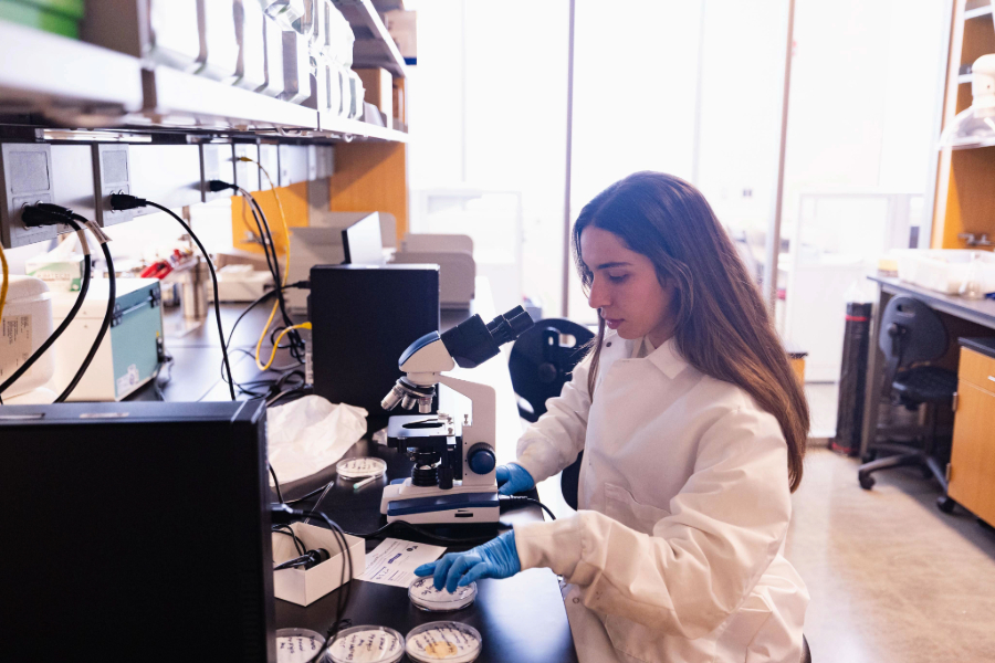 25-04-28 BIO 4300 as-1 CMU biology student performing class work in lab gear in the bio lab