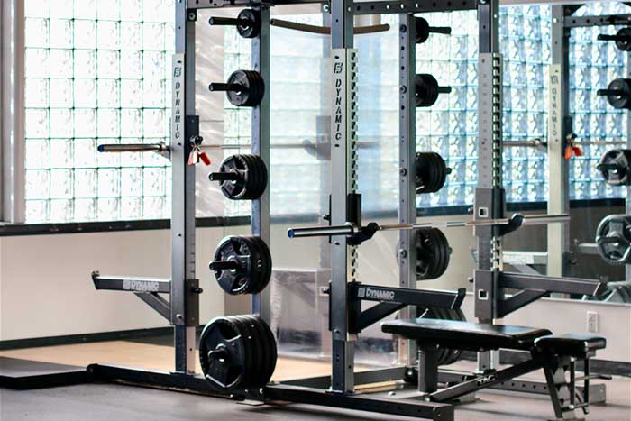 One of the weight stations in the fitness center that has a bar for bench and another for squat.