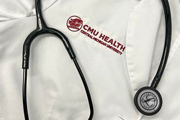 CMU Health white coat with stethoscope
